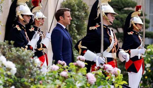 French President Macron stands as he reviews the troops during his swearing-in ceremony for a second term as president, at the Elysee Palace in Paris, France, May 7, 2022. 