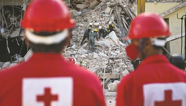 Rescuers remove debris from the ruins of Havanau2019s Saratoga Hotel.