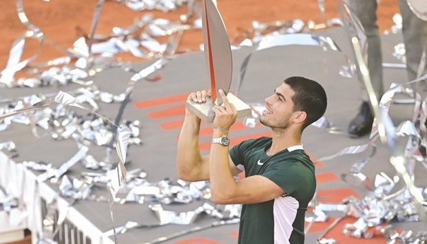 Spainu2019s Carlos Alcaraz celebrates with the trophy after winning the 2022 ATP Tour Madrid Open yesterday. (AFP)