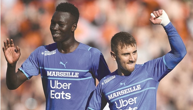 Marseilleu2019s French defender Jordan Amavi (left) and Marseilleu2019s French midfielder Valentin Rongier celebrate at the end of the Ligue 1 match against Lorient in Lorient, France. (AFP)