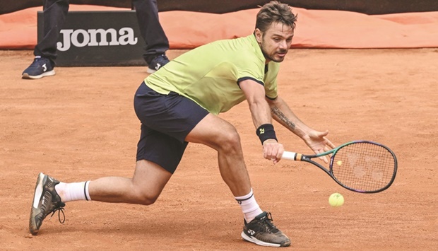 Switzerlandu2019s Stanislas Wawrinka returns to Reilly Opelka of the US during their first-round match at the ATP Rome Open at Foro Italico in Rome yesterday. (AFP)