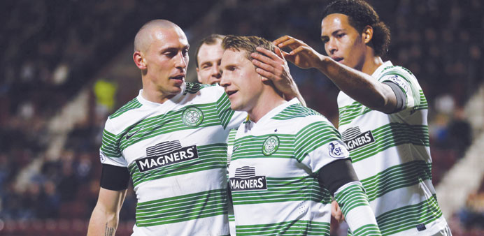 Celticu2019s Kris Commons (centre) celebrates his third goal against Hearts during their Scottish Cup match in Edinburgh yesterday. (Reuters)