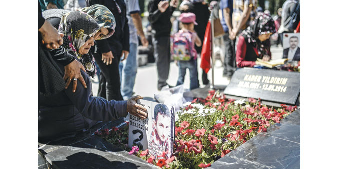 Relatives gather at the cemetery in the Turkish town of Soma yesterday to mark the first anniversary of the Soma mine disaster in which 301 workers we