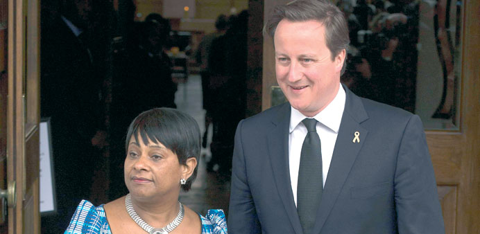 Prime Minister David Cameron stands beside Doreen Lawrence, mother of killed teenager Stephen Lawrence, outside St Martin-in-the-Fields Church in cent