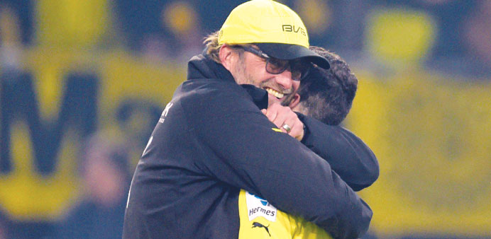 Borussia Dortmundu2019s coach Juergen Klopp (left) hugs Robert Lewandowski after their Bundesliga match against Wolfsburg on Saturday. (EPA)