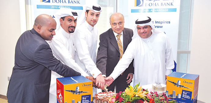 Doha Bank and Al Sulaiman Travels officials celebrate the highest redemption of Dream loyalty points for January 2013.
