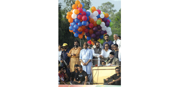 Tahir-ul-Qadri speaks to supporters in Islamabad yesterday.