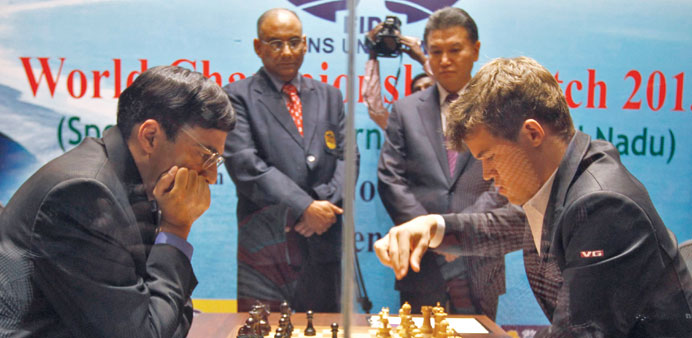 Norwayu2019s Magnus Carlsen (R) makes a move against Indiau2019s Viswanathan Anand during the FIDE World Chess Championship in Chennai yesterday. (Reuters)
