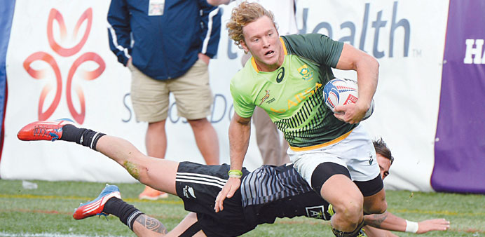 Werner Kok (left) of South Africa scores a game-winning try ahead of Ambrose Curtis of New Zealand in the Cup Final match during the USA Sevens Rugby 