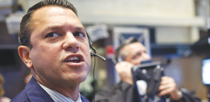 Traders work on the floor of the New York Stock Exchange yesterday. The Dow Jones Industrial Average was down 0.69%, while the tech-rich Nasdaq Compos