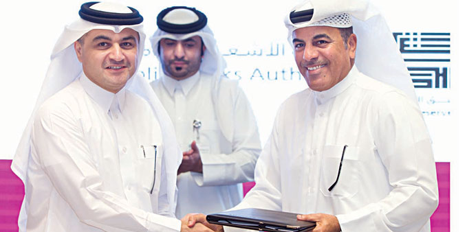 Al-Mawlawi and al-Kuwari at the agreement signing ceremony.