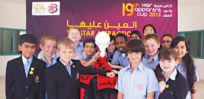 Schoolchildren with HH the Heir Apparent Cup football trophy.