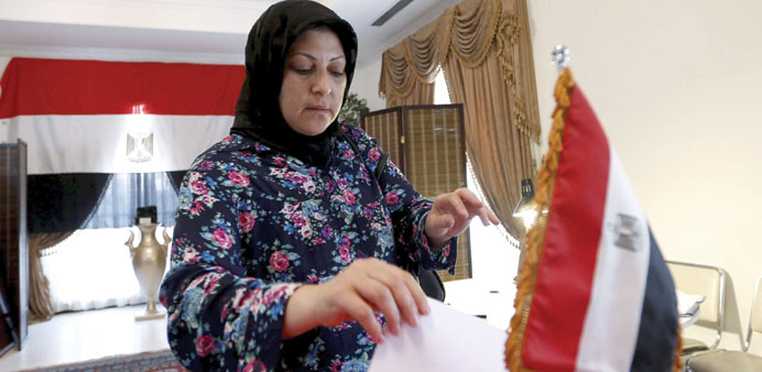 An Egyptian woman living in Bahrain casts her vote at the Egyptian embassy in Manama yesterday.