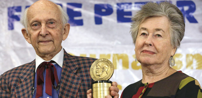 Juris Greste and his wife Lois show off the Peabody trophy won by Peter Greste during a news conference in Nairobi.