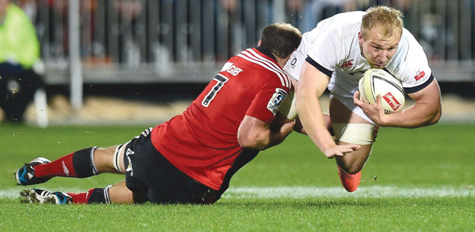 Englandu2019s openside flanker Matt Kvesic (right) is tackled by Canterbury Crusaders captain and openside flanker George Whitelock during their rugby uni