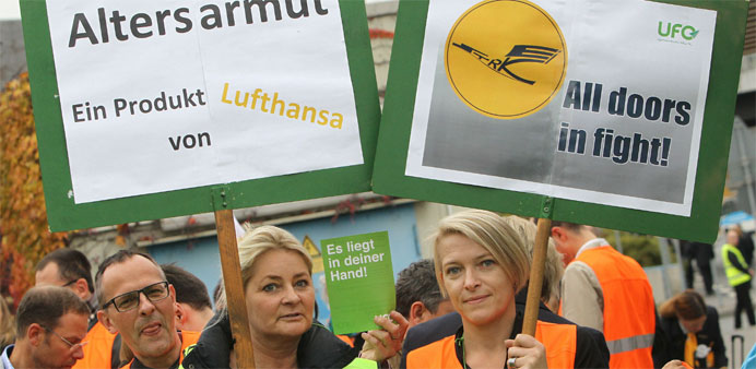 Cabin staff of German airline Lufthansa hold placards during a demonstration outside the airport in Frankfurt 
