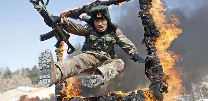 A soldier jumps through a ring of fire during a tactical training mission in Heihe, northeast Chinau2019s Heilongjiang province.