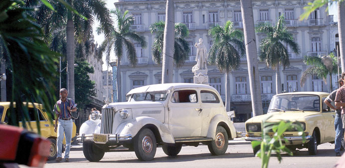    *  A classic US car from from the 1940s at left, and a Soviet-era car at right. Both are part of daily life in Cuba.