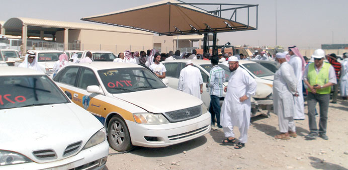 Potential bidders inspecting the vehicles on display.