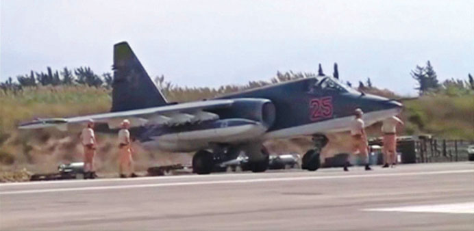A frame grab taken from footage released by Russiau2019s defence ministry yesterday shows technicians gathering around a Russian air force Su-25 military 