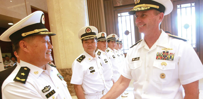 US Chief of Naval Operations Admiral Jonathan Greenert (right) meets senior officers during a welcoming ceremony at the PLA Navy headquarters outside 
