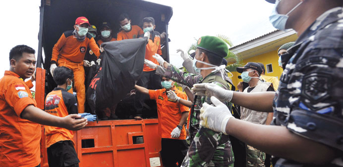 Rescue team members and soldiers unload the body of a victim of the sunken ferry Marina Baru at the Shiva hospital in Wajo, Indonesiau2019s South Sulawesi