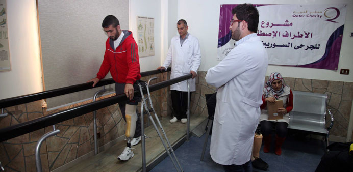  A wounded Syrian being trained to use his artificial limb.