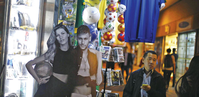 A cut-out of model Gisele Bundchen (left), a sixth-generation German Brazilian and star footballer Neymar is pictured in Porto Alegre. (Reuters)