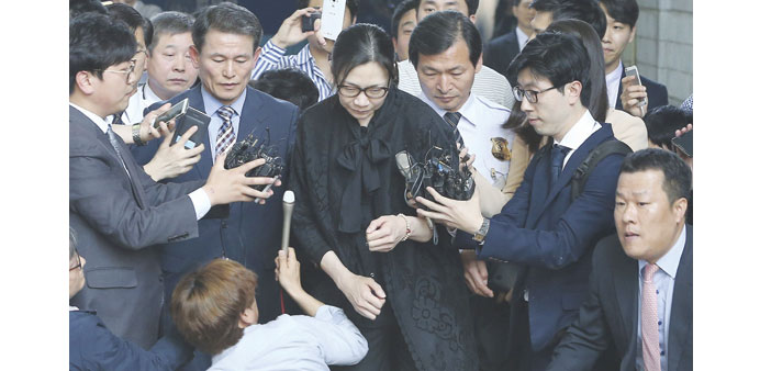 Former Korean Air Lines executive Heather Cho (centre)  is surrounded by reporters as she is released at a courthouse in Seoul yesterday.