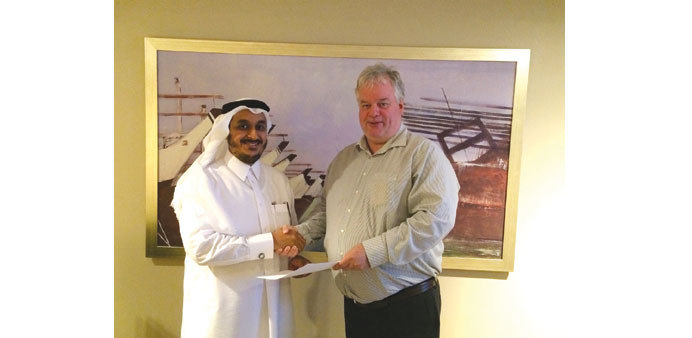 Al-Ansari, left, and Neureiter shaking hands after forming a joint venture that aims to professionalise Qataru2019s CSR initiatives.