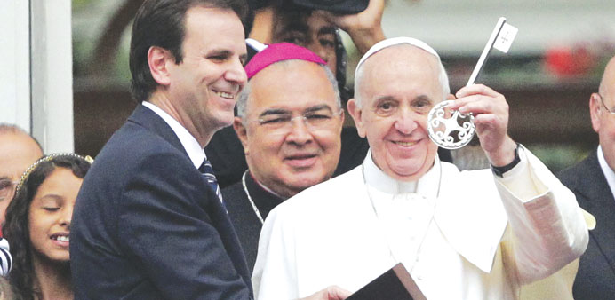 Pope Francis holds up the symbolic key to the city received from Rio de Janeiro Mayor Eduardo Paes at Guanabara Palace in Rio de Janeiro.