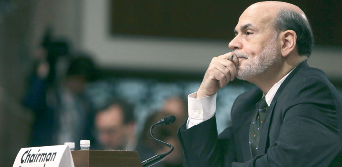 Bernanke listens to opening remarks before testifying at the Joint Economic Committee in Washington, yesterday.