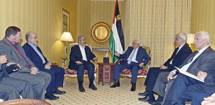Palestinian President Mahmoud Abbas meeting with Hamas leader Khalid Mishal in Doha yesterday.