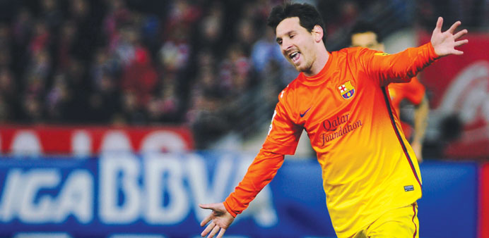 Barcelonau2019s Argentinian forward Lionel Messi celebrates after scoring against Granada at the Nuevo Los Carmenes stadium in Granada on Saturday.