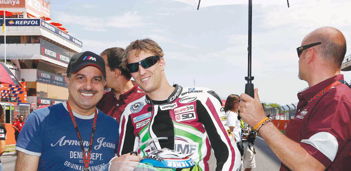 QMMF president Nasser Khalifa al-Attiyah with the teamu2019s Moto2 Rider Anthony West before the start of the race in Catalunya.