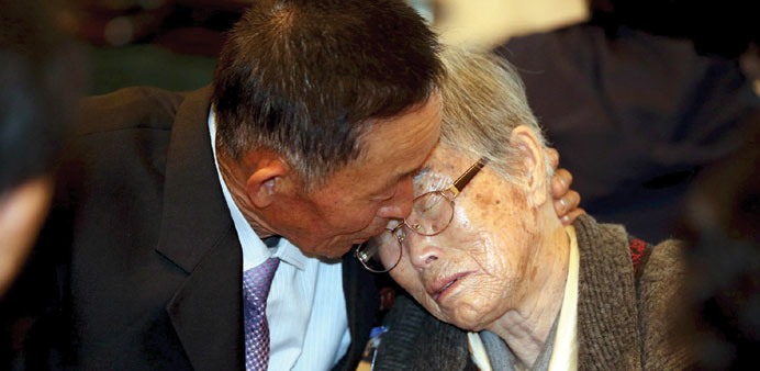 South Korean Lee Kum Seok bids farewell to her North Korean son Han Song Il.