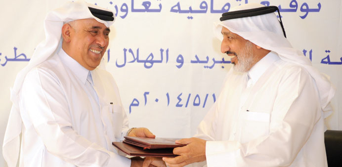 Al-Aqaily exchanging the MoU with al- Mohannadi. Picture: Shaji Kayamkulam