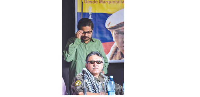 The head of Farc delegation holding peace talks with the Colombian government, commander Ivan Marquez (standing) and commander Jesus Santrich, are pic