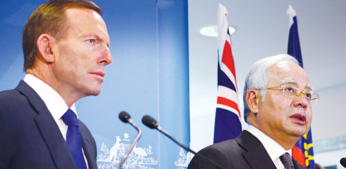 Australian Prime Minister Tony Abbott and Malaysian Prime Minister Najib Razak speak to members of the media after a bilateral meeting at the Commonwe