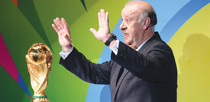 Spain coach Vicente Del Bosque poses with the FIFA World Cup trophy during the final draw in Costa do Sauipe, Brazil, yesterday. (EPA)