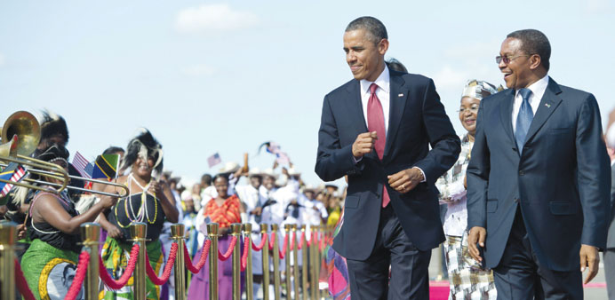 US President Obama dances alongside Tanzanian President Jakaya Kikwete upon arrival at Julius Nyerere International Airport in Dar es Salaam yesterday