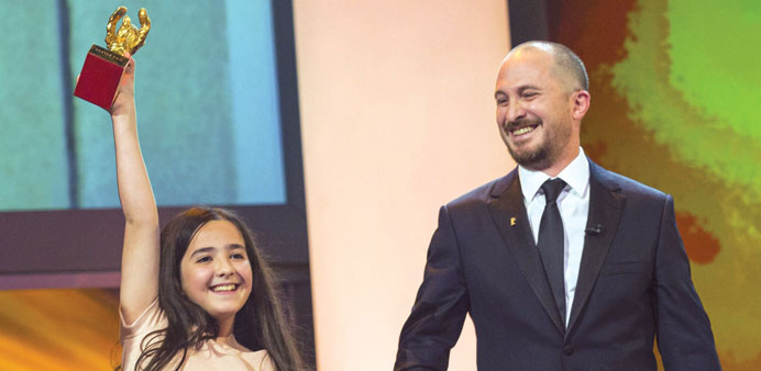 International jury president, producer Darren Aronofsky, watches as the niece of Iranian film director Jafar Panahi accepts the Golden Bear for Best F