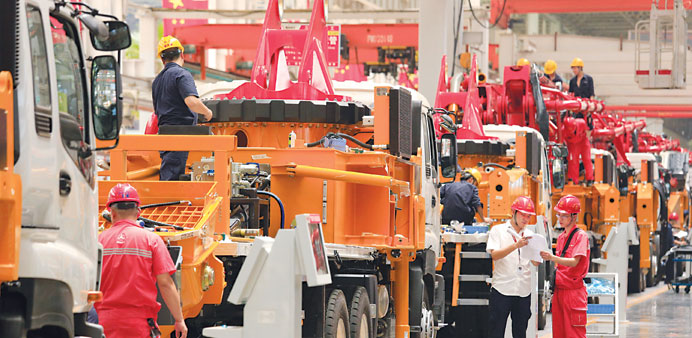 Employees work on the manufacture of construction machinery in an assembly shop in Changsha, Hunan Province, China. The PMI has fallen to a 5-month lo
