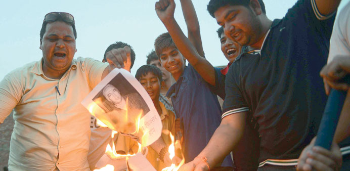 Cricket fans burn photogarphs of Indian actor Vindu Dara Singh during a demonstration in the city of Amritsar in Indiau2019s Punjab state yesterday. (AFP)