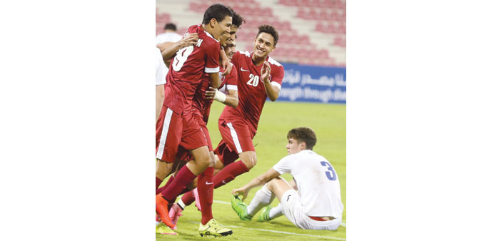 Qatar players celebrate after scoring a goal yesterday.