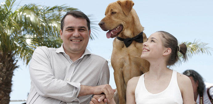 Hungarian director Kornel Mundruczo, dog actor Hagen and actress Zsofia Psotta pose during the photocall for Feher Isten (White God).