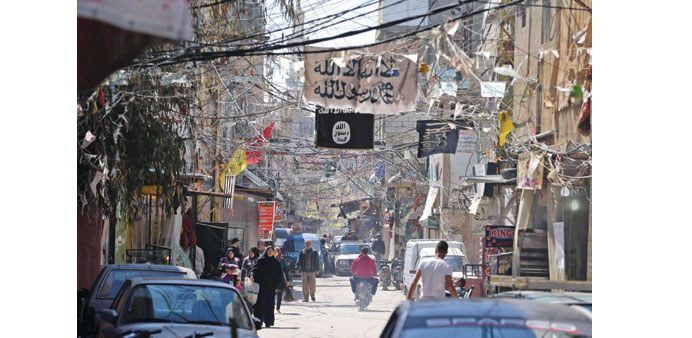 Electric cables and Islamist flags hang over a street dominated by Islamist factions in the refugee camp of Ain al-Helweh, near the southern Lebanese 