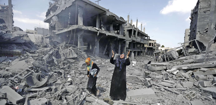 A woman reacts amid destroyed buildings in the northern district of Beit Hanoun in the Gaza Strip during a 12-hour truce yesterday.