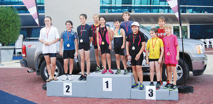 THE CHAMPIONS: The winners of junior section of the GMC Second Triathlon TriSeries Doha pose at the podium.