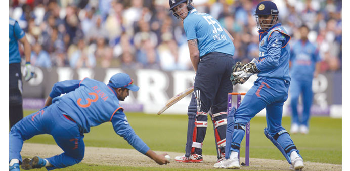 Englandu2019s Ben Stokes looks back as he is caught brilliantly by Indiau2019s Suresh Raina as skipper MS Dhoni looks on during the third one-day internationa
